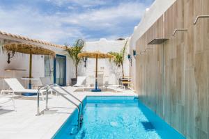 a swimming pool with a patio and a house at CapoBlu Hotel in Pula