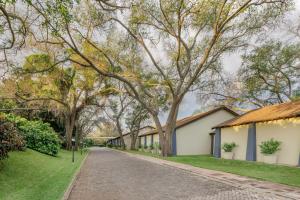 a street of houses with trees and grass at Protea Hotel by Marriott Livingstone in Livingstone