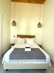 a bedroom with a large bed with two pendant lights at Casa aOrta Studios in Faro