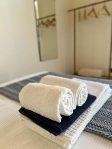two towels sitting on top of a bed at Casa aOrta Studios in Faro