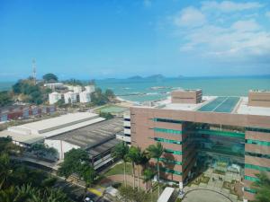 uma vista aérea de um edifício e do oceano em Hotel Champs Dumont em Macaé