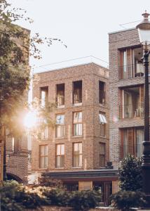 a brick building with the sun shining on it at Wex Hotels in Fredrikstad