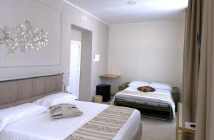 a hotel room with two beds and a window at Chiostro San Francesco - Casa di Ospitalità Religio sa in Naples