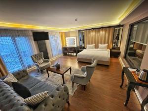 a hotel room with a bed and a living room at Bloom Suite Hotel in Kesan +28 photos