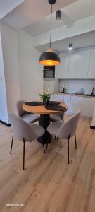 a dining room table and chairs in a kitchen at Apartament Moje Dąbrówno in Dąbrówno