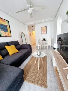 a living room with a couch and a table at TorreSol Apartment in Torrevieja