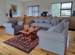 a living room with two couches and a coffee table at Sundays River Mouth Guesthouse in Colchester