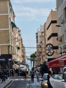 a busy city street with people walking down the street at TorreSol Apartment in Torrevieja