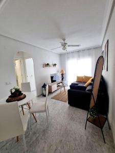 a living room with a couch and a table at TorreSol Apartment in Torrevieja