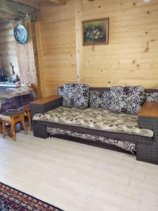 a living room with a couch and a table at Cottage Lisovychok in Vorokhta