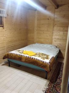 a room with a bed in a wooden room at Cottage Lisovychok in Vorokhta