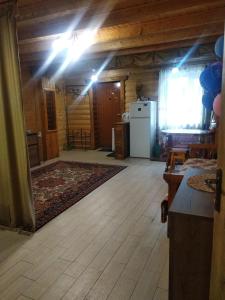 a room with a kitchen and a refrigerator in a house at Cottage Lisovychok in Vorokhta