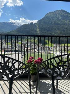 un banco sentado en la parte superior de un balcón con flores en Hotel Zalwonder en Ischgl