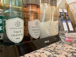 a group of bottles of liquid cleaning products on a counter at Hotel La Rouge - Vacation STAY 89068v in Fukushima