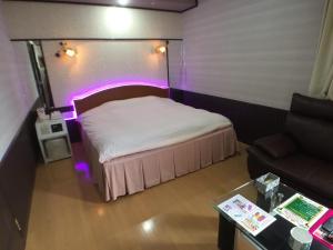 a bedroom with a bed with purple lights on it at Hotel La Rouge - Vacation STAY 89068v in Fukushima