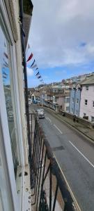 a view of a street from a balcony of a building at The Ugly Duckling in Brixham