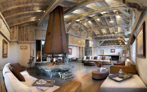 a large living room with a large fireplace in a building at CGH Résidence Boutique Le Hameau De Pierre Blanche in Les Houches