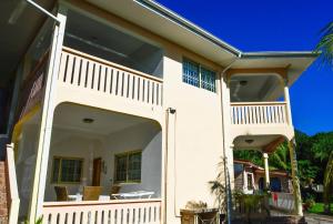 a large white house with a large balcony at HORIZON selfcatering in Beau Vallon