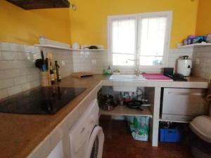 a kitchen with a sink and a counter top at Maison T3 avec jardin (8pers) in La Crau