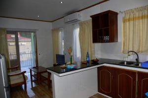 a kitchen with a sink and a counter top at Chez Antoine Apartments in Grand Anse