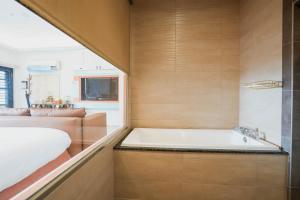 a bathroom with a tub and a sink at 墾丁曜星海Villa-海景第一排 in Hengchun