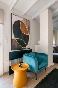 a living room with a blue couch and a table at fragoseco loft! Elegance & Luxury in Chalkida