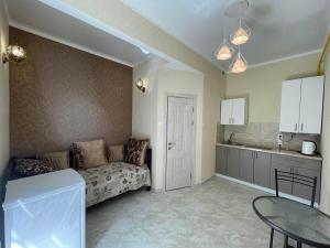 a living room with a couch and a table at Апартаменти в парку in Uman