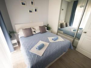 a bedroom with a bed with two towels on it at Rita Apartments - Sea-view apartment 2plus1 in Tučepi