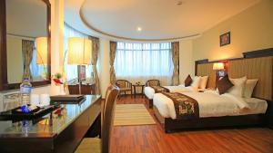 Rúm í herbergi á Hotel Mirage Regency