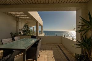 a view of the ocean from the balcony of a house at Beach View Apartment in Cottesloe in Perth