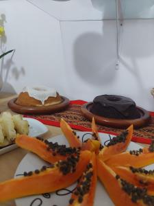 a table with plates of food on a table at Encantos do mar in Arraial do Cabo