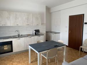 a kitchen with a table and chairs in a room at Residence Salvatici in Castelnovo neʼ Monti