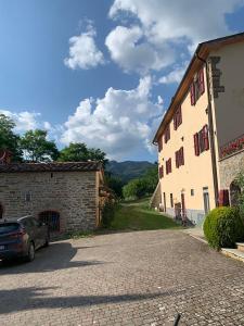 a car is parked next to a building at Le Mulina ristoro in Barberino di Mugello