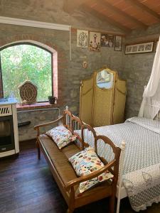 a bedroom with a bed and a fireplace and a window at Le Mulina ristoro in Barberino di Mugello