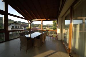 a dining room with a table and chairs on a balcony at Casa Diecilor in Vatra Dornei