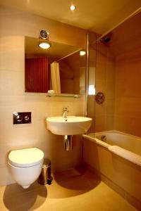 a bathroom with a toilet and a sink at The Royal Toby Hotel in Rochdale