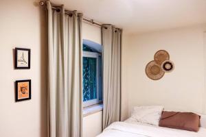 a bedroom with a bed and a window at Charming Jerusalem Home in Jerusalem