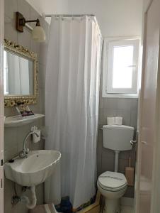 a bathroom with a sink and a toilet and a window at Sea View in Loutraki +87 photos