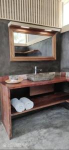 a bathroom with a sink and a mirror and towels at Yvea house in Santana