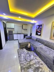 a living room with a couch and a table at Primal Msquare Apartment Ikoyi in Lagos