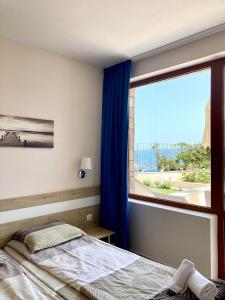 Ліжко або ліжка в номері Apartments in Villas Apolon