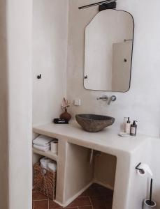 a bathroom with a sink and a mirror at The Mykonos House - Newly Renovated Villa Near Town in Mýkonos City +32 photos