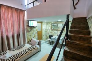 a bedroom with a staircase and a bed and a stair case at Garden Villa Lake Side & Glamping in Ksamil