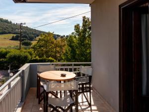 a table and chairs on a balcony with a view at Zafira Retreat in Vatopedi