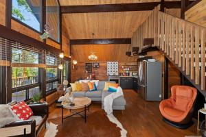 a living room with a couch and a kitchen at New!!! Dreamy Bear Haus- Updated Retro Retreat & Spa, Pet & Kid Friendly in Big Bear Lake