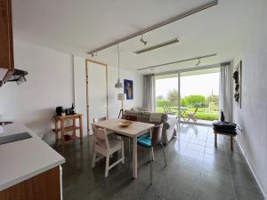 a kitchen and living room with a table and a couch at ArtbyPraXis in Governors Beach