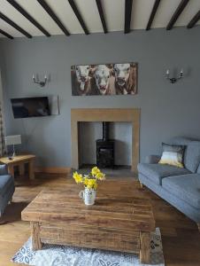 a living room with a couch and a coffee table at The cottage in Alston