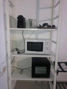 a white shelf with a microwave and a toaster oven at Relais Florence in Florence