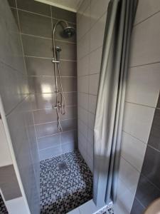 a bathroom with a shower with a shower curtain at Sweet guesthouse in Mostar +14 photos