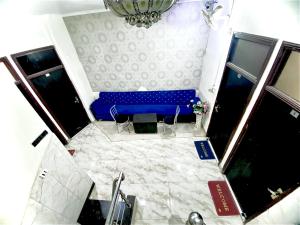 a blue bench sitting in the middle of a room at Swaran hotel in Amritsar